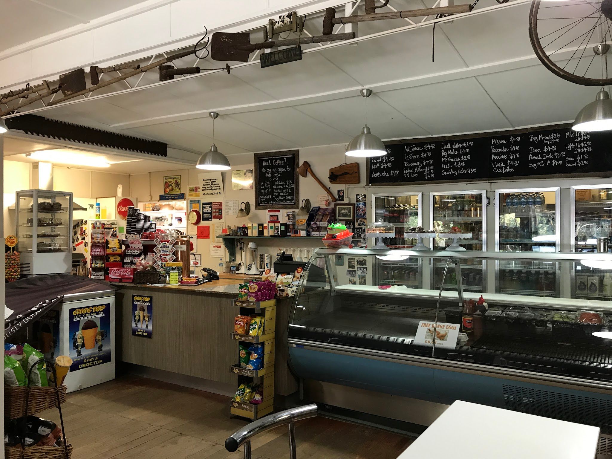 Red Hill General Store interior café counter with deli display case, pendant lights, and chalkboard menu