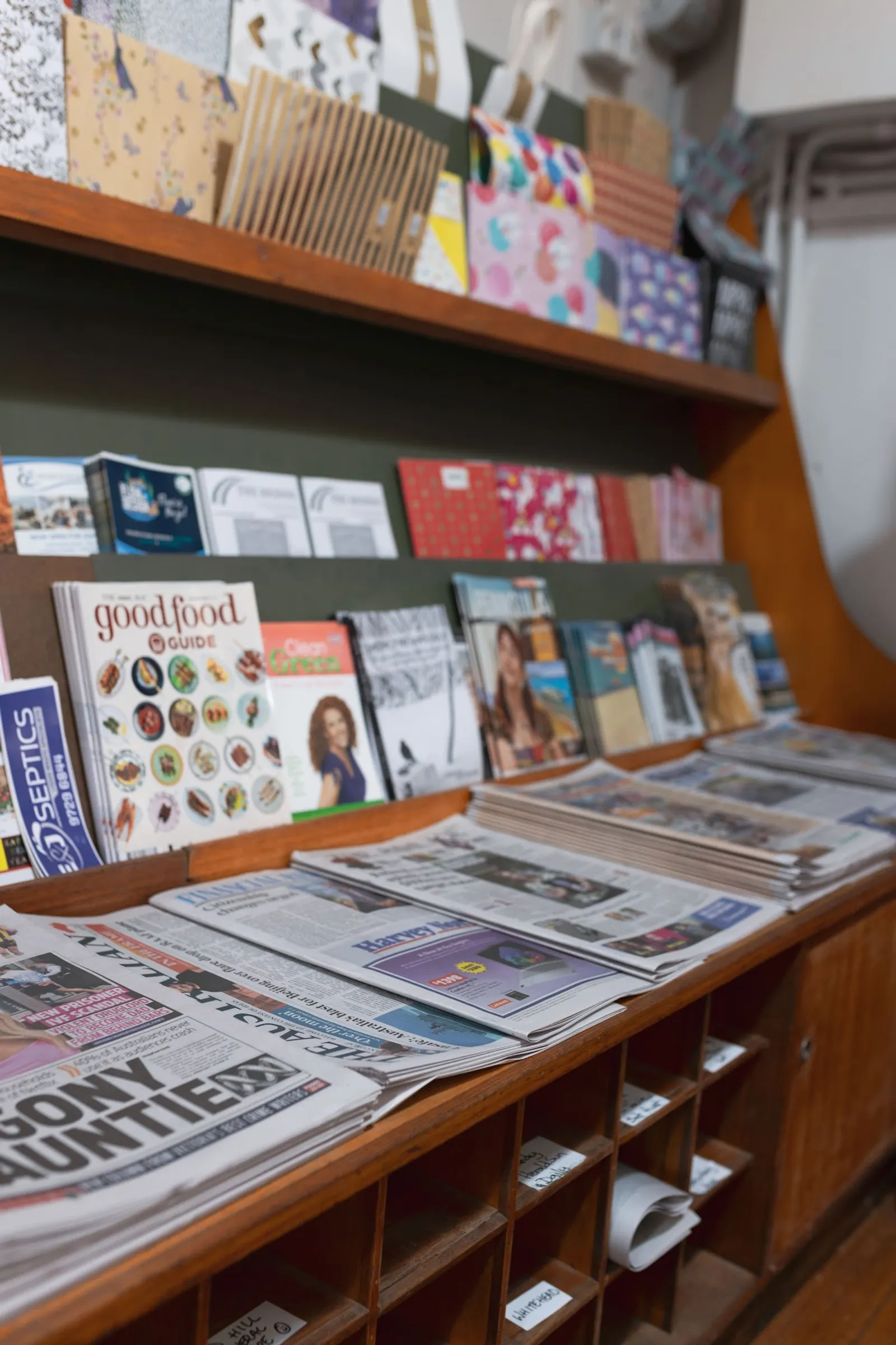 Red Hill General Store wooden magazine and newspaper rack with papers, magazines, and stationery